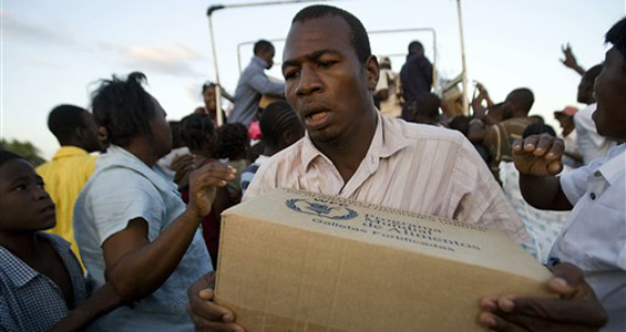 haiti and cuba, man with box of aid