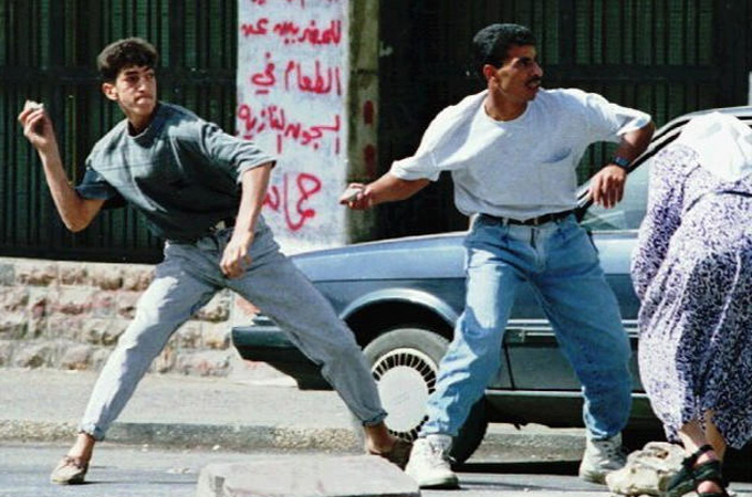 Palestinians throw rocks during the first intifada