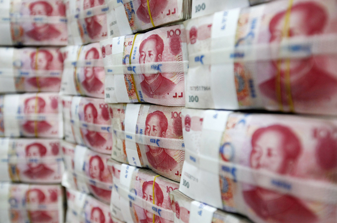 Inside Story - File photograph of Chinese yuan notes piled up after counting at a bank during a photo opportunity in Seoul