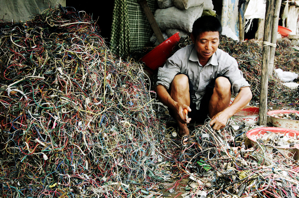 Chinese e-waste gallery - Chinese worker sorts through wires and cables