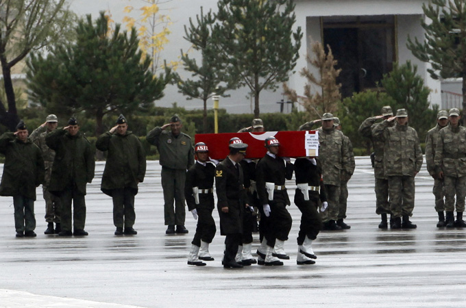 Soldiers carry a coffin containing the body of a Turkish soldier towards a waiting plane in Van October 20, 2011. The soldier was one of 24 soldiers killed in an attack by PKK Kurdish rebels in southeastern Turkey on Wednesday. REUTERS