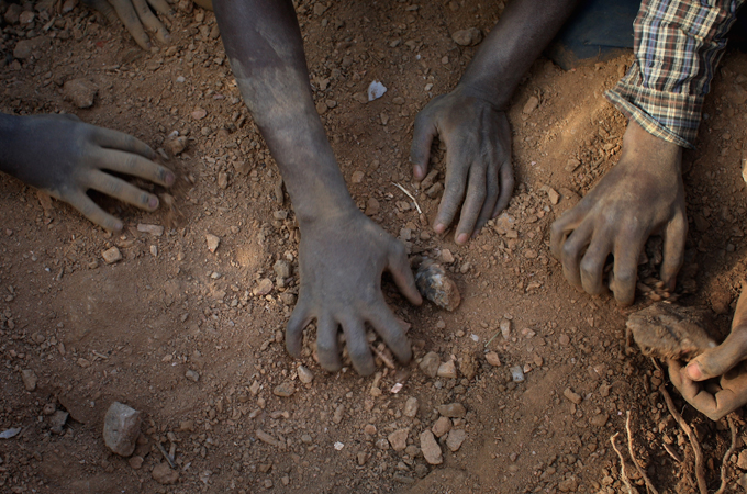 Gold miners scratch a living by digging in primitive mines and panning for flecks of gold for a licensed supervisor on the outskirts of Bulawayo, Zimbabwe