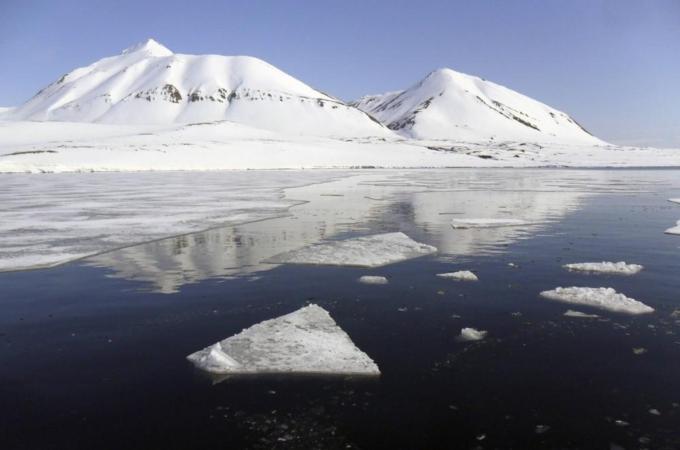 Snow-covered mountains look over the Isfjord in Svalbard