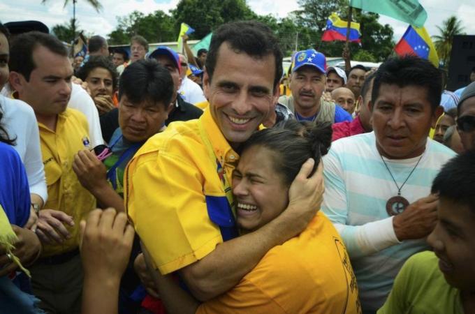 A supporter embraces opposition candidate Henrique Capriles during a rally in Santa Elena de Uairen in the southern state of Bolivar