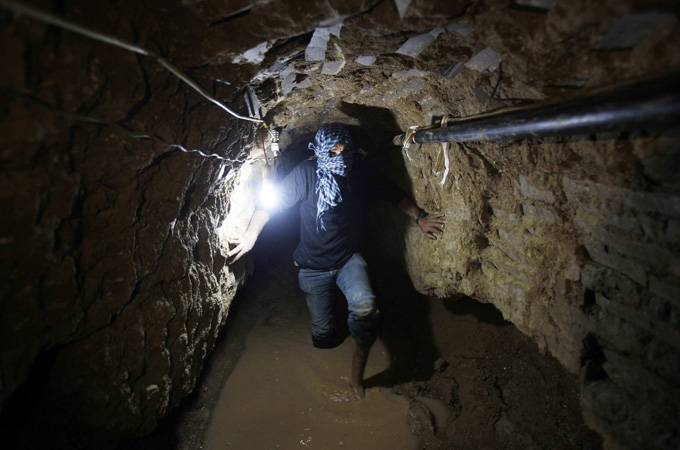 A Palestinian works inside a smuggling tunnel flooded by Egyptian forces