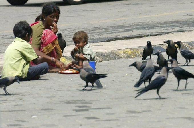 An Indian street woman watched by a coll