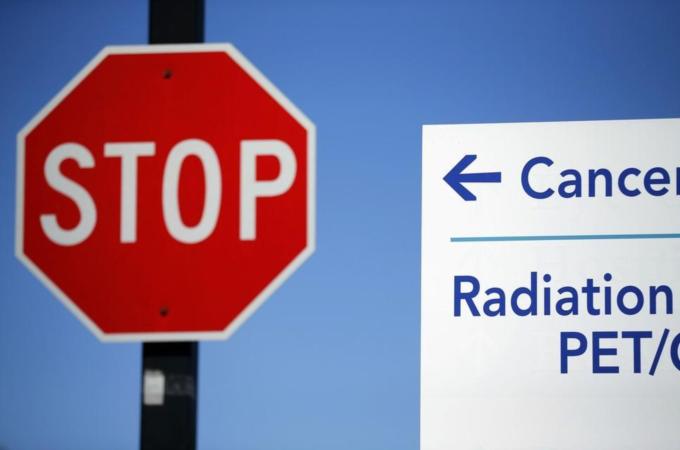 A sign pointing to the Rebecca and John Moores UCSD Cancer Center DNA Sequencing facility at UCSD in San Diego