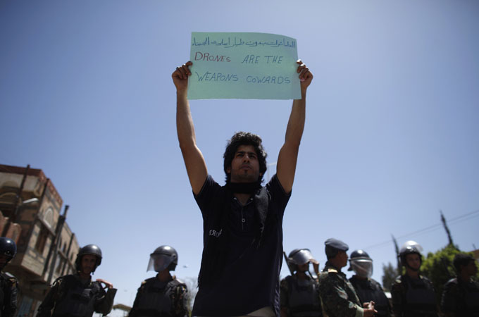 An activist holds up a placard during a protest against the U.S. drone strikes in Yemen outside the U.S. embassy in Sanaa