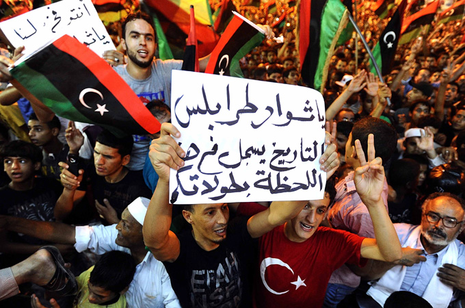 People celebrate the capture in Tripoli of Muammar Gaddafi''s son