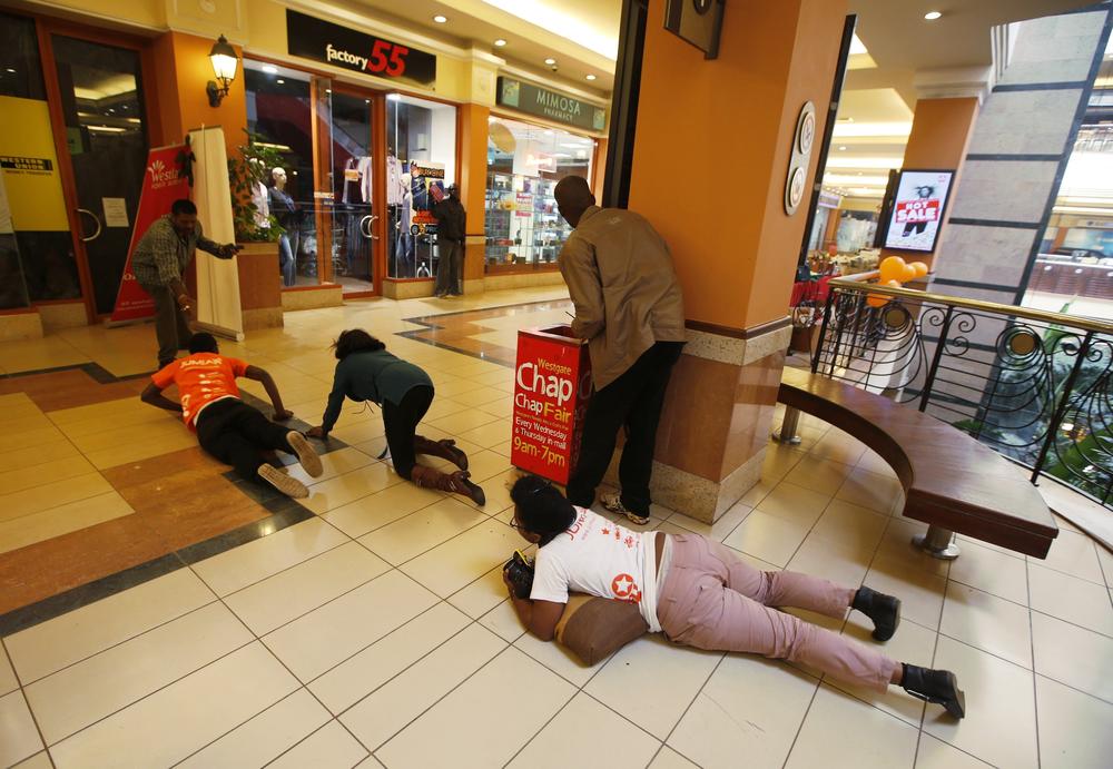 People scramble for safety as armed police hunt gunmen who went on a shooting spree at Westgate shopping centre in Nairobi