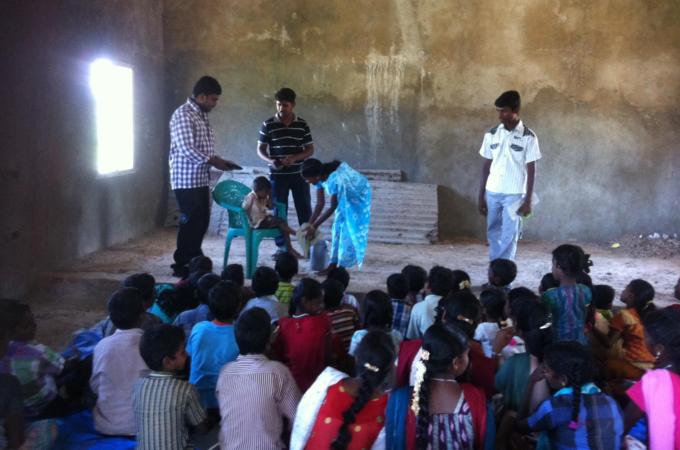 Volunteers interact with children of Sonavanthottam hamlet in Tamil Nadu [V Prem Shanker/ Al Jazeera]