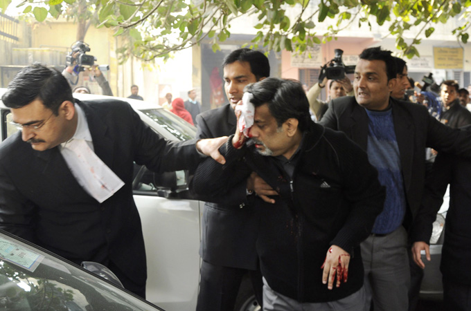 Besides spending time in jail, Rajesh Talwar, centre, has also been physically attacked [File: AP]