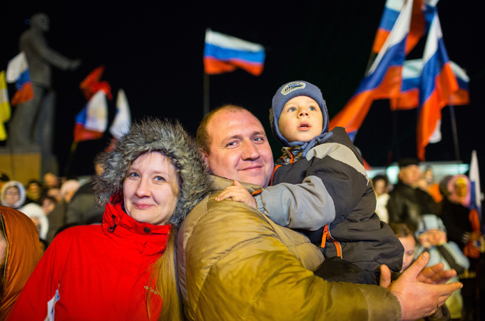 A family joining celebrations in Lenin Square after the end of a referendum in Simferopol, Crimea [EPA]