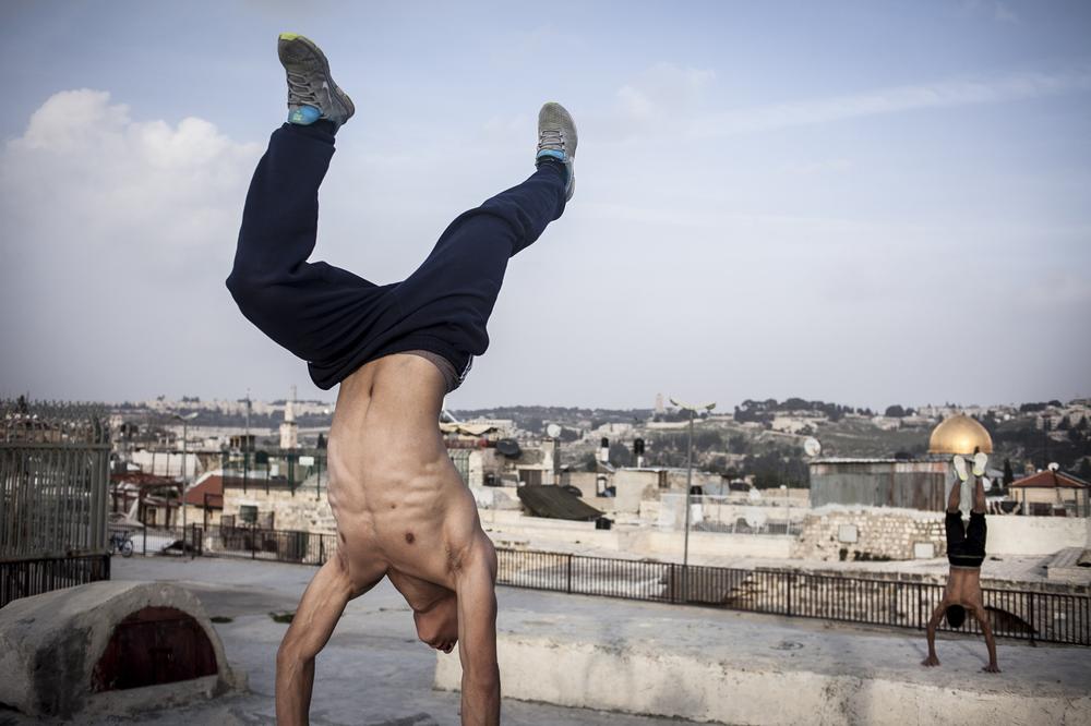<p>Muhamad and Sami rehearse an acrobatic routine before starting <em>parkour</em>, which combines elements from martial arts, gymnastics, rock climbing and other athletic fields.</p>