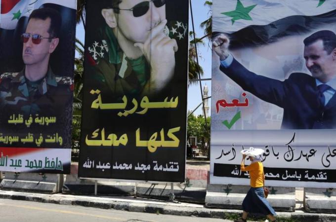 Campaign posters line the streets of Damascus ahead of Tuesday's poll [AFP]