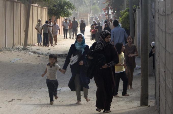 Palestinian families flee as Israel's army continues shelling Khan Yunis in the southern Gaza Strip [AFP] 