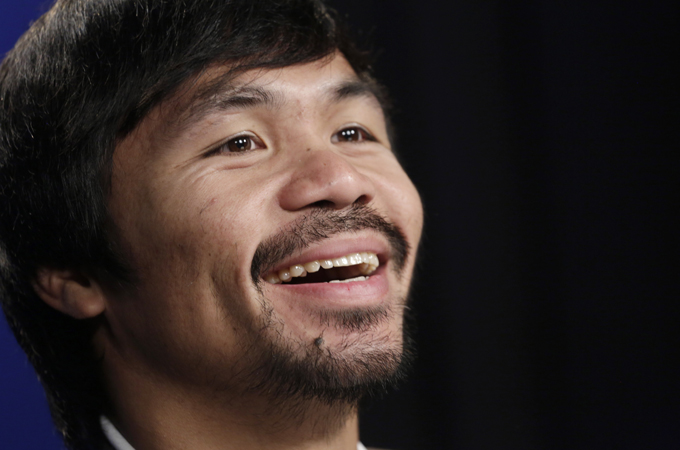 Boxer Manny Pacquiao is the first fighter in history to bag eight world titles in as many weight divisions [AP]