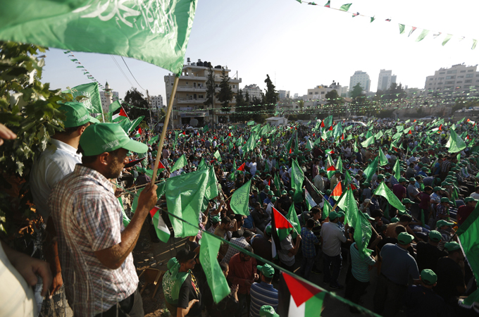 Waving Palestinian and Hamas flags, thousands rallied in Ramallah when the Gaza war ended [Reuters]