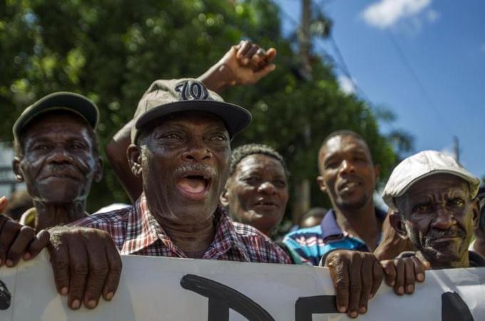 Haitian sugar cane workers demand Haitian passports needed to regularise their status in Dominican Republic [AFP]