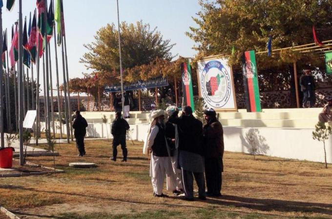 Afghan members of the Loya Jirga speak before the meeting outside its premises in Kabul [AFP]