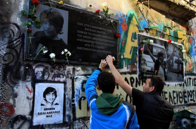 Students place flowers at the spot were teenager Alexandros Grigoropoulos was fatally shot by a Greek police officer [EPA]