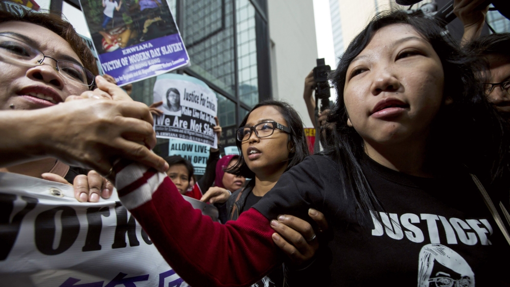 Erwiana Sulistyaningsih, a former Indonesian domestic helper, is greeted by her supporters outside a district court in Hong Kong