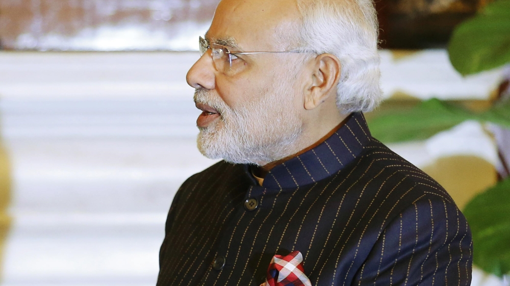 Indian Prime Minister Modi, wearing a dark pinstripe suit repeatedly embroidered with the words "Narendra Damodardas Modi", meets with U.S. President Barack Obama in New Delhi