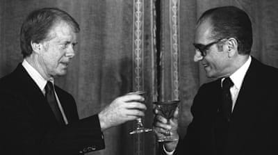 Former US President Jimmy Carter toasts the Shah Muhammad Reza Pahlavi of Iran during New Year's Eve dinner at Niavaran Palace in Tehran on December 31, 1977 [AP]