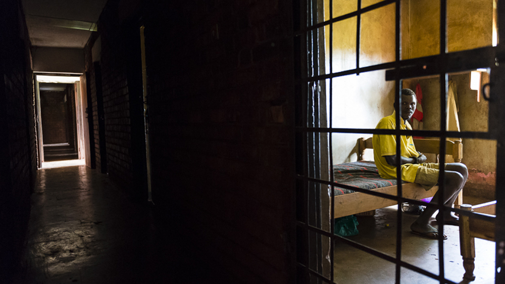 Peter is locked up for his own safety. Having drunk a bad batch of crude waragi, he now suffers from chronic mental health issues and needs constant care [AJ Heath/Al Jazeera]