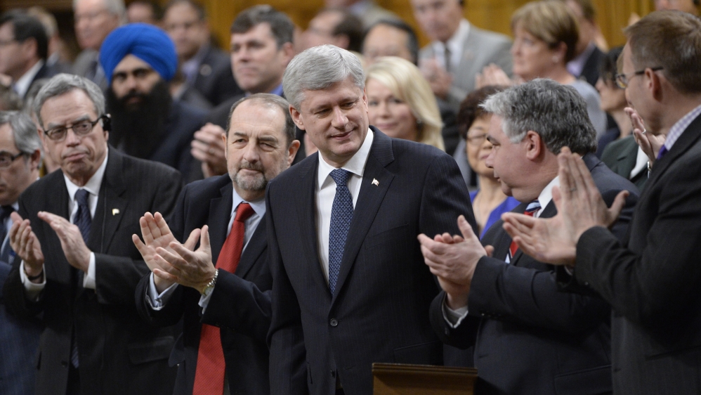 Harper is applauded after introducing a motion in the House of Commons to expand and extend Canada''s war against ISIL [AP]