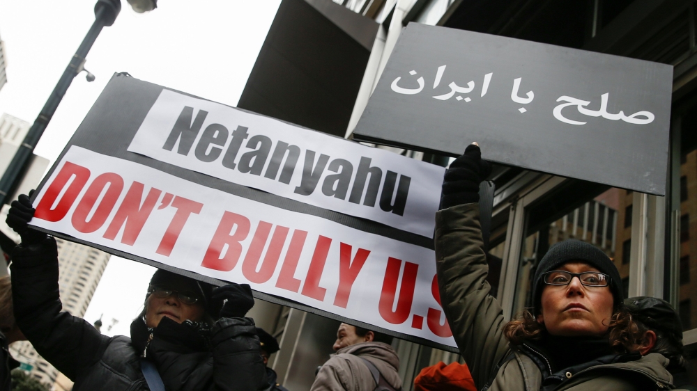 Demonstrators hold signs during a rally near the Israeli Consulate in New York City [Reuters]