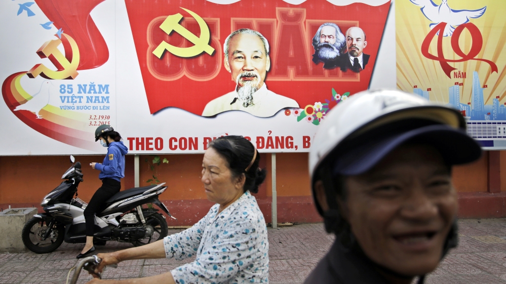 A Communist Party banner bearing portrait of Vietnamese national hero Ho Chi Minh and communist leaders Karl Marx and Vladimir Lenin is displayed on a street in Ho Chi Minh City [AP]