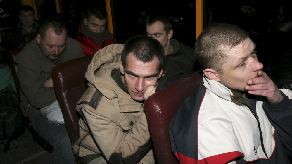 Members of the Ukrainian government forces, who are POWs, sit inside a bus after they were freed by pro-Russian rebels in the settlement of Maryinka outside Donetsk
