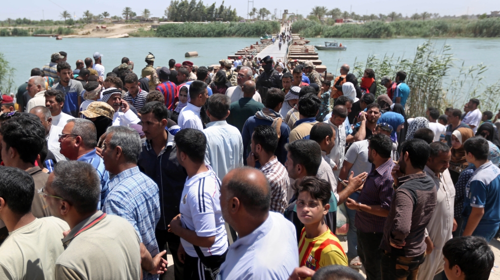Displaced Iraqis from Ramadi gather at the Bzebiz bridge after spending the night walking towards Baghdad [AP]