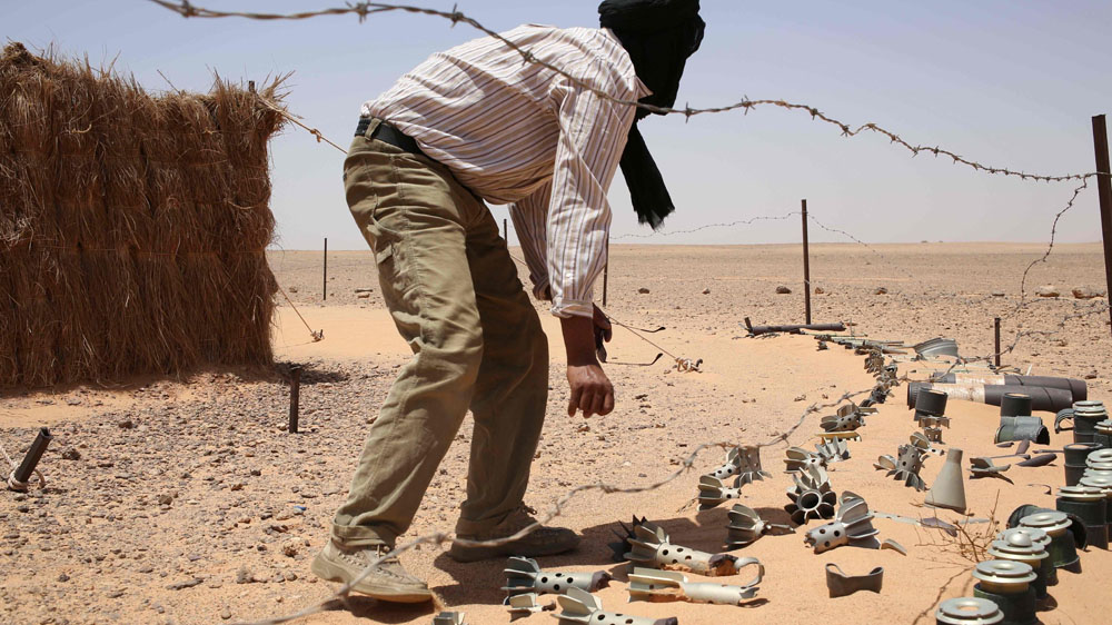 A man near the Berm at a house built to symbolise resistance where remnants of war have become art [Hannah McNeish/Al Jazeera]