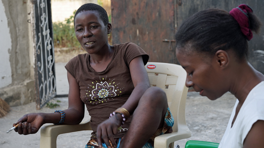 Sandra and Hadija outside Malaika Sober House, one of the island's two centres for women [Abigail Higgins/Al Jazeera]