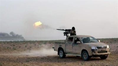 ISIL fighter in a battle against Syrian forces on a road between Homs and Palmyra [AP]