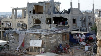 Palestinian children play next the remains of their house in Gaza City [AFP]