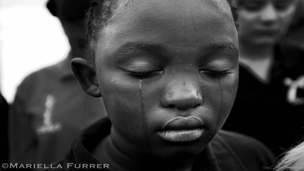 A schoolmate of Sheldean Human cries during her memorial service. Two weeks after her disappearance, Sheldean's body was found after a confession by a 25-year-old man. She had been sexually molested and murdered. Pretoria, March 2007 [Mariella Furrer]