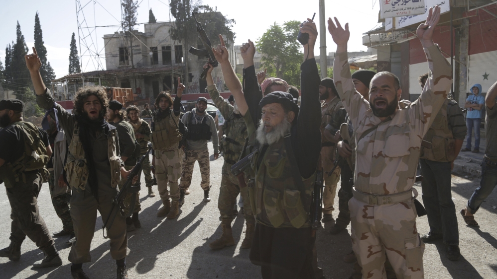 Members of al Qaeda''s Nusra Front cheer in the northwestern city of Ariha, after a coalition of insurgent groups seized the area in Idlib province [REUTERS]