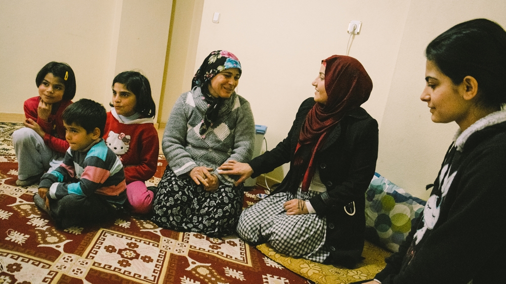 Berivan Elif Kilic visits a family from the Syrian town of Kobane. Around 450 Syrian Kurdish refugees now live in the village [Bradley Secker]