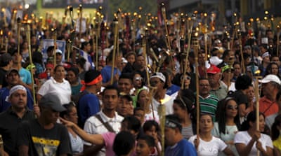 Protesters chanted slogans against Hernandez as they marched to the presidential palace [Reuters] 