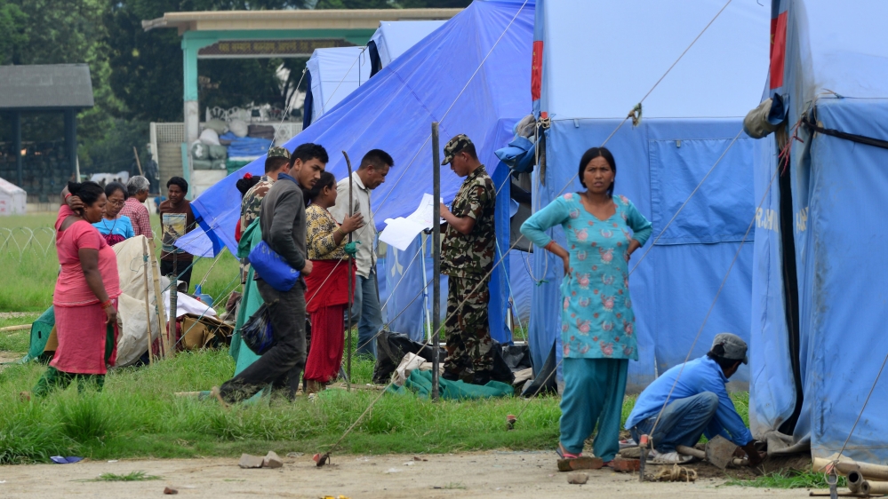 Tens of thousands of people still live in makeshift camps as the rebuilding efforts have yet to gather steam [AFP]