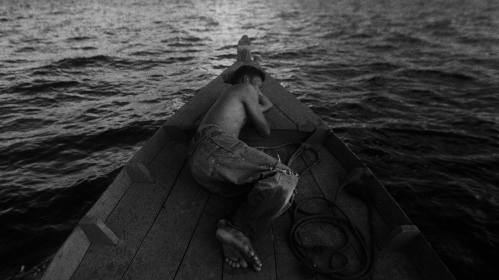 A young illegal immigrant from Myanmar sails from that country to the Thai port town of Ranong [Jack Picone]