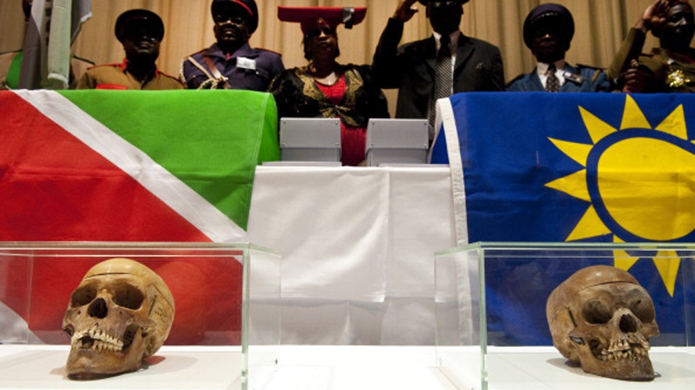 Members of a Namibian delegation stand by Skulls of victims