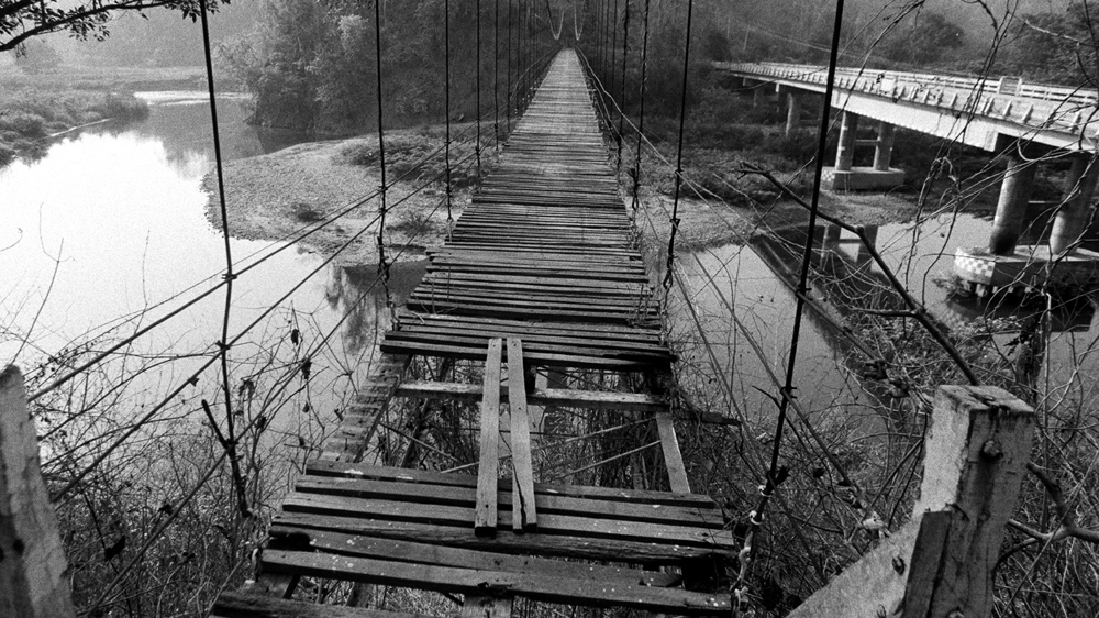 A broken bridge runs parallel with the Thai-Myanmar border [Jack Picone]