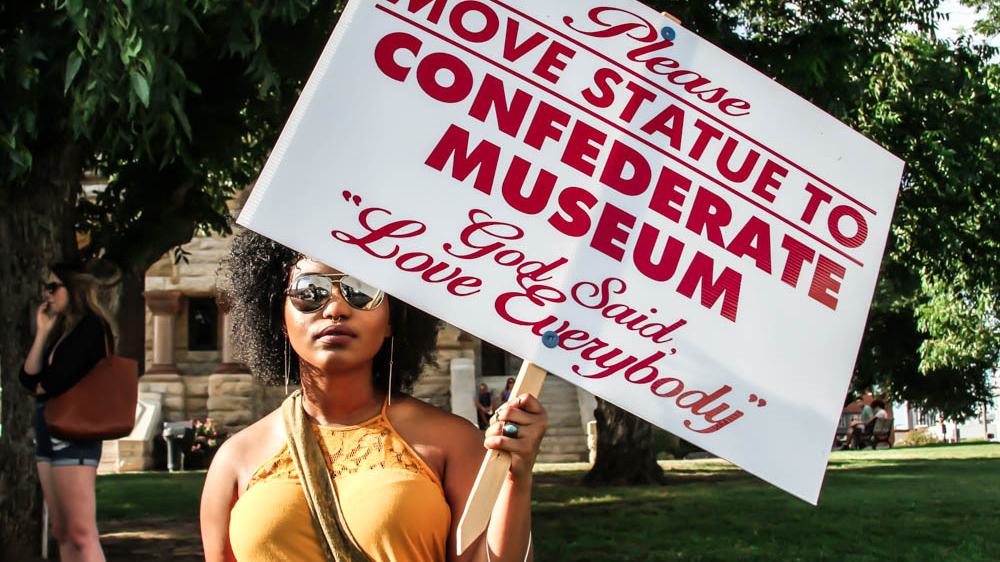 Local activists gathered in front of the Denton Municipal Court House to protest the Confederate Soldier Monument and demand its transfer to a museum [Shaghayegh Tajvidi/Al Jazeera]