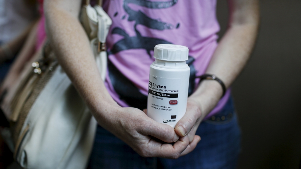 An activist of the All-Ukrainian Network of People Living With HIV/AIDS holds an empty package of the drug Aluvia, as she takes part in a rally in front of the Ukrainian cabinet of ministers building