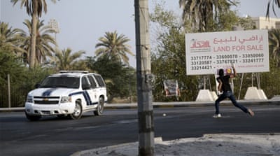 A Bahraini protester throws a stone towards riot police during clashes following a demonstration to mark Bahrain's independence day [Getty]