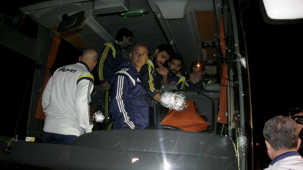 Fenerbahce''s players Emre, Alper, Bekir and Coach Ismail Kartal are seen in team bus which was shot while it has been driven through to Trabzon Airport